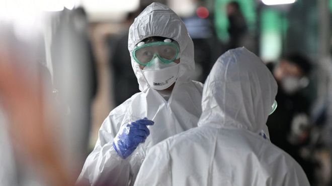 An Asian medical worker in protective gear